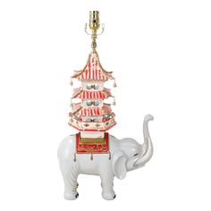 an elephant with a pagoda on its back is standing in front of a white background