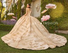 a woman in a wedding dress standing on the grass with pink flowers behind her and an advertisement for abc fashion