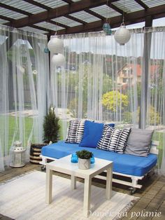 a blue couch sitting on top of a white table