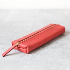 This is pencil case made of the classy veg-tanned coral pink color soft leather. The leather will grow patina over time and will become darker, add more glossy, and the color will be richer. Unlike the pencil case you found in a regular stationery shop, the leather we select actually comes with natural growing grain and texture. You can put at least 15 pens in it and also can easily locate your pen every time you fetch it. ● 20.5 x 3 x 7 cm (Actual capacity: 19x2x6cm. Please put items shorter th Coral Pink Color, Rosa Coral, Leather Pencil Case, Board Pin, Red Flats, Tan Cowhide, Pen Pouch, Pencil Cases, Leather Projects