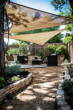 an outdoor patio area with furniture and shade