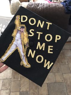 someone is holding up a graduation cap that says, don't stop me now