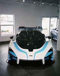 a white and blue sports car in a showroom