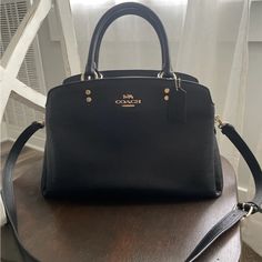 Used A Few Times. Looks Brand New. Designer Black Bag With Handles, Designer Black Bags With Handles, Luxury Black Satchel With Removable Pouch, Luxury Black Satchel With Top Carry Handle, Classic Black Handheld Satchel, Black Handheld Satchel With Top Carry Handle, Classic Black Satchel With Detachable Handle, Designer Black Bag With Detachable Strap, Chic Black Top Handle Satchel