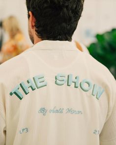 the back of a man's shirt that says the show