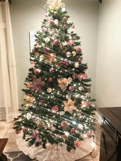 a decorated christmas tree in the corner of a room