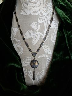 This is a stunning rare antique shakudo necklace.The necklace is Japanese and was made in the 1920s era.The necklace is made of brass and black enamels.The necklace consists of a series of fluted circles and ovals,all linked together.Hanging from the necklace is a larger fluted roundel with a teardrop shape hanging from it..All the pieces are handpainted in 24ct gold.The designs feature traditional Japanese scenes of landscapes featuring trees,water,mountains,pakodas.All executed in beautiful fi Victorian Antique Gold Necklace For Formal Occasions, Victorian Antique Finish Collectible Necklace, Ornate Medallion Necklaces With Vintage Charm, Ornate Medallion Necklace With Vintage Charm, Traditional Medallion Necklace With Vintage Charm, Antique Medallion Necklace For Formal Occasions, Victorian Pendant Necklace With Antique Finish, Victorian Engraved Necklaces For Ceremonial Occasions, Victorian Locket Necklace For Ceremonial Occasions