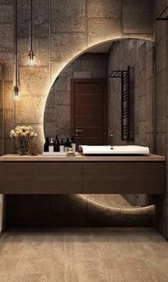 a bathroom with a sink, toilet and mirror in it's center wall that is made of stone