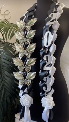 two black and white sashes with flowers on them