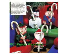 cross stitch christmas ornaments with candy canes and snowman on them, in the shape of santa's helpers