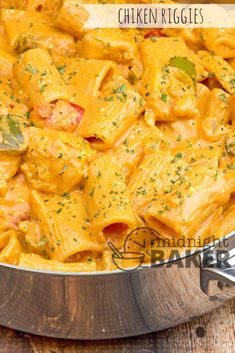 a pan filled with pasta and cheese on top of a wooden table