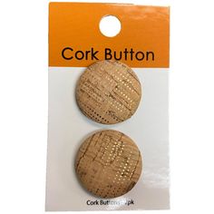 two cork buttons with holes in the middle