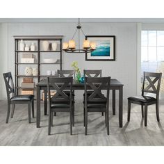 a dining room table with chairs and shelves