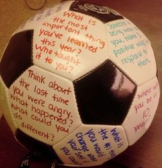 a close up of a soccer ball on a table with writing written on the side