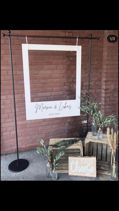 two wooden crates with plants in them next to a sign that says mama and lily