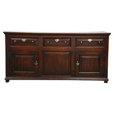 an old wooden dresser with many drawers and knobs on the front, against a white background