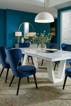 a dining room table with blue chairs around it