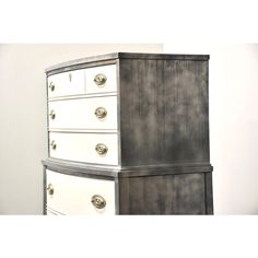 an old dresser has been painted white and gray