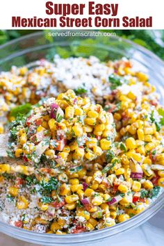 mexican street corn salad with cilantro, red onion, and parsley in a glass bowl