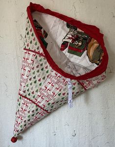 an upside down red and white umbrella on the ground