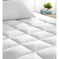 an all sizes one price mattress is shown in front of a bed with white sheets and pillows