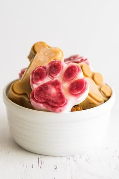 a white bowl filled with dog treats on top of a table