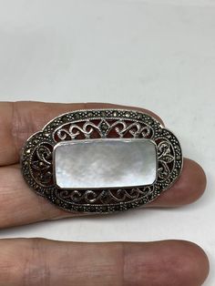 Vintage Pin Marcasite 925 Sterling Silver Brooch Vintage brooch All 925 sterling silver Genuine Marcasite and mother of pearl About 2 inch All jewelry is shipped free in the US in a nice gift box. Check out our over a THOUSAND great reviews Engraving is $4 per letter and is not always perfect depending on the piece. It can take a few days if the jeweler is busy. This is payable to Paypal Judithsltd@gmail.com White Oval Brooch For Anniversary, Victorian White Brooch For Anniversary, Elegant Silver Brooches Stamped 925, White Oval Brooches For Gifts, Classic Silver Brooches As Gifts, White Sterling Silver Brooches As Gift, White Hallmarked Brooches As Gift, Antique White Brooches As Gift, White Antique Brooches As A Gift