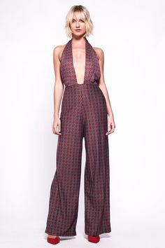 Young hearts, run free in this disco inspired wide leg, deep V plunge halter neck lycra jumpsuit. Deep red / maroon with a gorgeous ornate tile print.  - Halterneck tie  - Deep V neck to waist - Bare back - Stretchy lycra  - Wide leg  Model wear S/M Chic Printed Jumpsuits And Rompers For Party, Jumpsuit 70s, 70s Mode, Halter Neck Jumpsuit, Leg Model, Womens Jumpsuits, Blue Tile, Tile Print, 70s Style