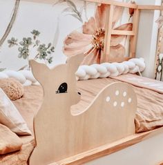 a wooden deer head on a bed in a child's room