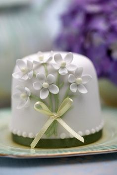 a white cake decorated with flowers on a plate