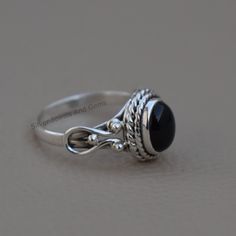 Gemstone-Black Onyx Shape-Oval Metal-925 Sterling Silver This One of a kind ring is adorned with beautiful Black Onyx gemstone in sterling silver.Black Onyx is the birthstone representing the month of December. About gemstone- Black Onyx is the birthstone for Leo. It is the stone of protection.This elegant smooth textured stone is said to have immense healing and spiritual benefits.Black Onyx symbolizes peace,harmony and love and good luck.Black Onyx is well known to remove negativity and act as Black Oval Cabochon Jewelry For Anniversary, Black Sterling Silver Jewelry With Oval Cabochon, Black Oval Cabochon Sterling Silver Jewelry, Birthstone Promise Rings, Watermelon Tourmaline Ring, Oxidized Silver Rings, Emerald Cut Rings, Black Onyx Ring, Onyx Ring