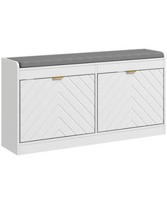 an image of a white cabinet with two doors and grey cushioning on the top