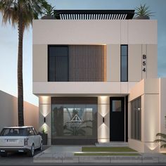 a car is parked in front of a modern house with palm trees on the street