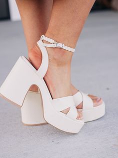 This gorgeous chunky sandal is bringing all the 70's glam. The Norah features a cross strap front and a sweet ankle buckle detail. Upper Material: Vegan synthetic upper Insole Material: Padded InsoleSole or Heel Material: Rubber outsole, leather wrap heel Bridal Shoes Platform Comfortable, Bridal Shoes Platform, Homecoming Heels, Bride 2024, 70s Glam, Ankle Strap Chunky Heels, Comfy Heels, Hoco Dress, Wrap Heels