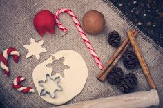 christmas cookies, candy canes and other decorations are laid out on a tablecloth