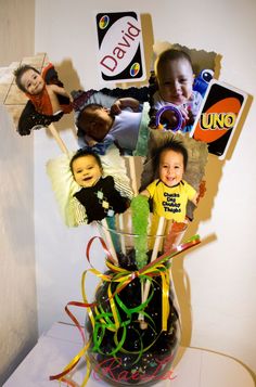 a vase filled with lots of different pictures on top of a table