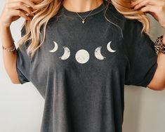 "Are you looking for the perfect way to express your celestial style? Look no further than this stylish Moon Phase Shirt! This Comfort Color tee gives you a relaxed stylish look. 🧡 Comfort Colors Unisex Shirt  🚚 Fast Shipping 👇🏼 Sizing & Shipping info below  👕 Printed using Direct To Garment style  SIZING  There is a sizing chart included in the images. This shirt fits like a normal unisex shirt so if you order your normal women's size, then it will be a nice relaxed fit. If you want an ove Celestial Style, Moon Phases Shirt, Celestial Shirt, Oversized T Shirt Dress, Moon Shirt, Comfort Colors Tee, Comfort Color, Great T Shirts, Quality T Shirts