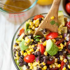 a salad with corn, tomatoes, avocado and black beans