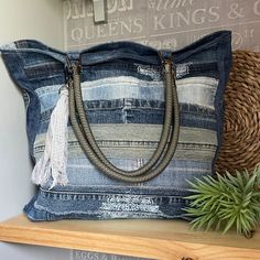 a denim bag sitting on top of a wooden shelf