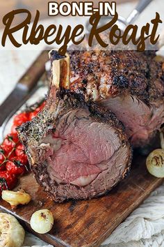 a roast beef on a cutting board with garlic and tomatoes next to it is the words bone of standing ribeye roast