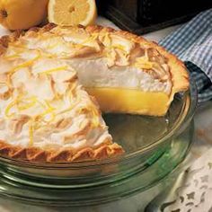 a lemon pie with one slice cut out and the rest on top of the pie