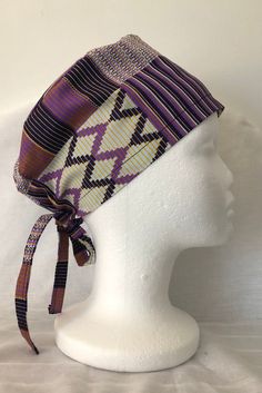 This is a handcrafted boho-style scrub cap made for medical professionals or anyone who likes to wear stylish headwear! It is made with 100 % Purple African Ankara Kente print which is unique in color and design. The cap has adjustable ties in the back that you pull on for a perfect fit. The fabric is breathable, comfortable, and washable. One size fits most. It is good for short or long hair. The buttons are wooden or plastic and will come in a variety of colors and patterns which is based on a Kente Print, Chemo Headwear, White Liners, Surgical Scrub Hats, Cool Masks, African Ankara, Scrub Hat, Scrub Cap, Scrub Hats