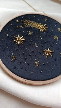 an embroidery project with gold stars on it