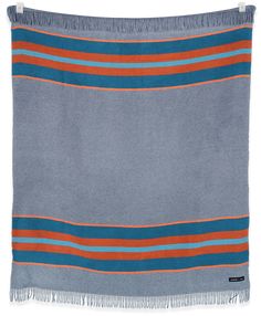 a blue and orange striped blanket with fringes