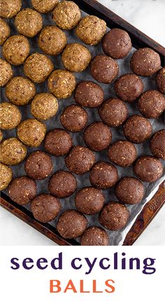 there is a tray full of balls on the table with text that reads, seed cycling balls