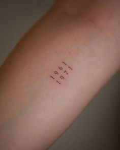 a person's arm with the word tattoo on it