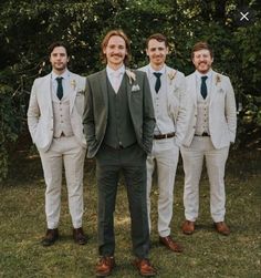 a group of men standing next to each other wearing suits and ties on the grass