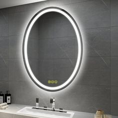 a bathroom with a sink, mirror and soap dispenser on the wall