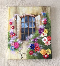 an image of a painting on the wall with flowers in front of it and a window