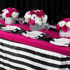 the table is set with black and white striped cloth